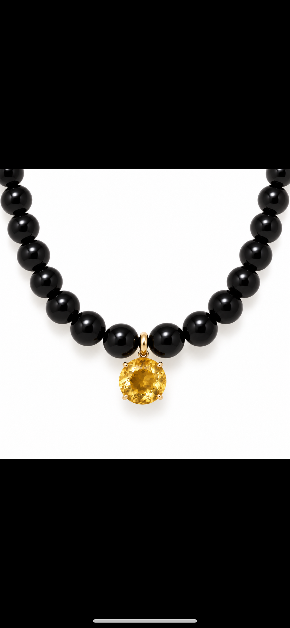 12 carat Citrin round Pendant set in 18k gold sits on all natural onyx beads with gold clasp.
